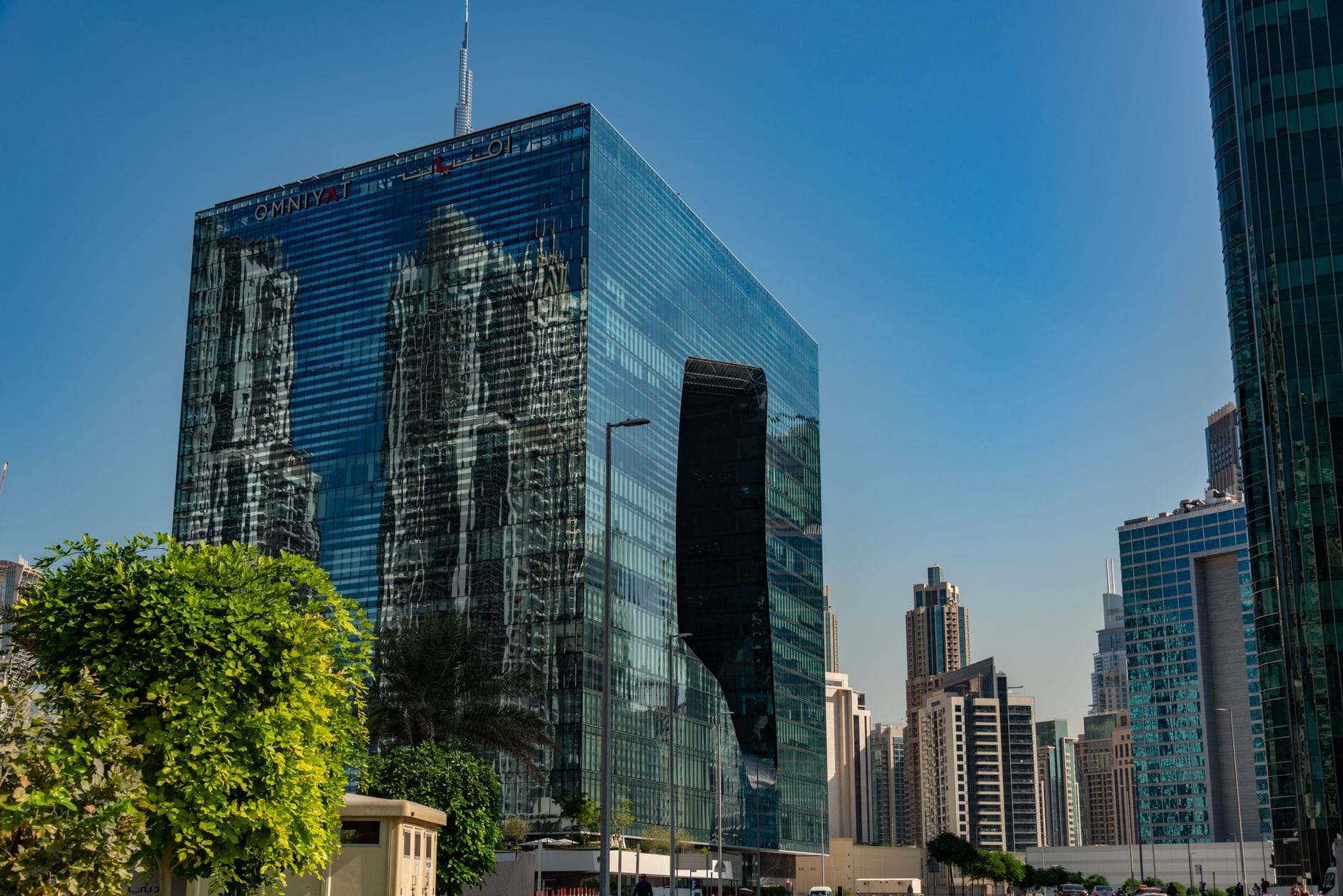 Skyscraper in urban cityscape with glass reflections on a sunny day.